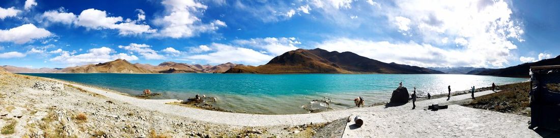 Panoramic view of sea and mountains against sky