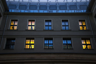 The building in berlin center, evening time, windows and night lights.