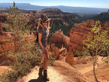 Woman standing on cliff at bryce canyon