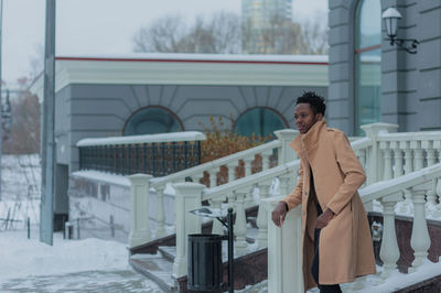 Man looking away while standing outdoors