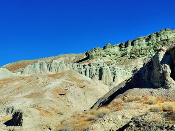 Scenic view of rock formation against clear blue sky