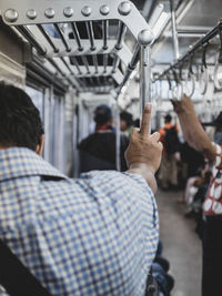 Rear view of man sitting in train