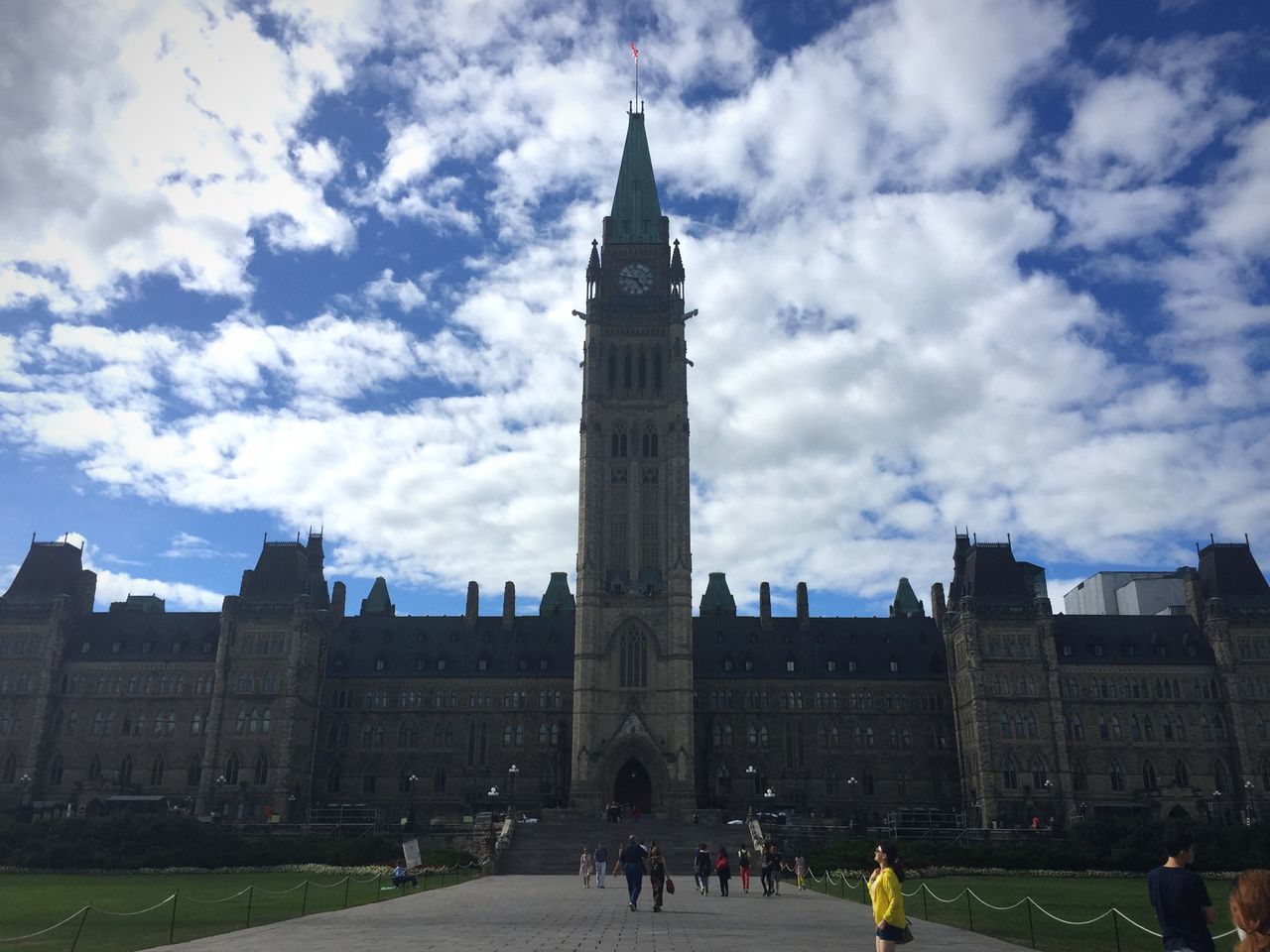 architecture, building exterior, built structure, sky, cloud - sky, city, men, large group of people, person, famous place, tower, travel destinations, lifestyles, cloud, city life, walking, cloudy, travel, tourism