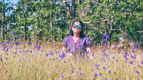 Portrait of smiling woman standing on lavender field