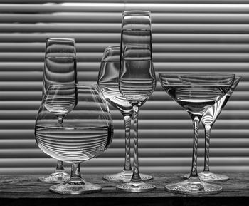 Close-up of wine glasses on table