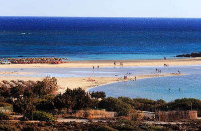 Scenic view of beach against blue sky