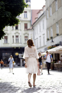 Rear view of women walking on street