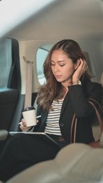 Young woman holding coffee cup