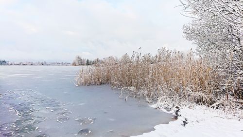 Scenic view of frozen lake against sky