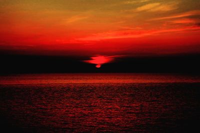 Scenic view of sea against romantic sky at sunset