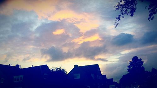 Low angle view of house against cloudy sky