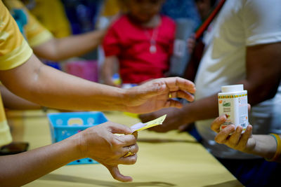 Midsection of people holding ice cream