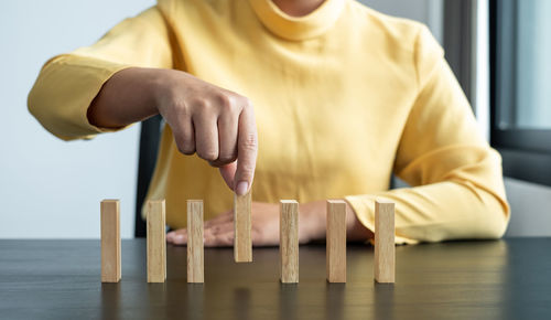 Close-up of woman arranging toy blocks