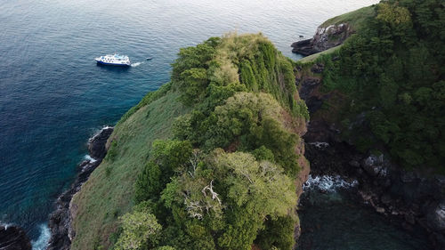 High angle view of sea by cliff against sky