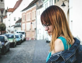 Young woman looking at city street