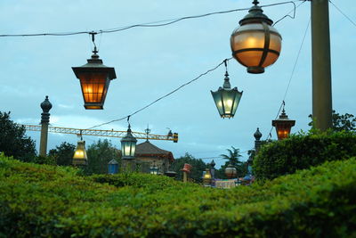 Illuminated street light against sky