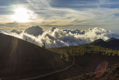 Clouds meeting mountains with a messy sky.