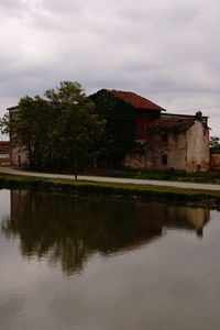 Scenic view of lake by building against sky