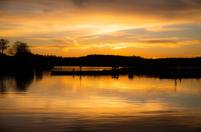 Scenic view of lake against orange sky