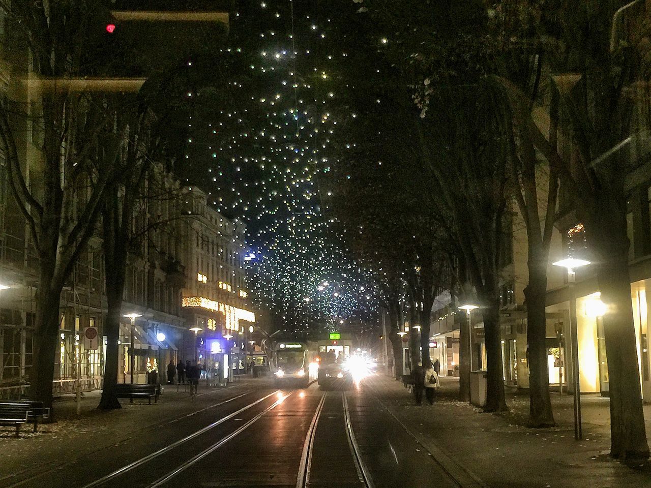 illuminated, night, transportation, the way forward, street, road, car, street light, city, building exterior, diminishing perspective, architecture, lighting equipment, built structure, land vehicle, city life, city street, road marking, mode of transport, vanishing point