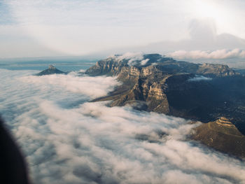 High angle view of sea and mountains against sky