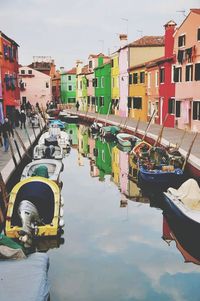 Boats in canal along buildings