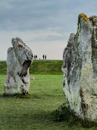 Rock formations on field against sky