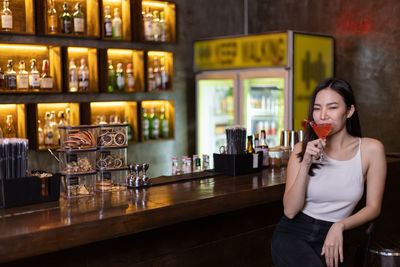 Portrait of a young woman drinking glasses