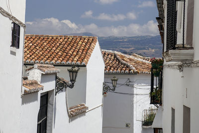 High angle view of white houses in town against sky