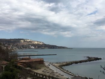 High angle view of sea and buildings against sky