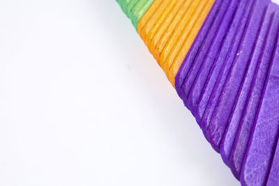 High angle view of multi colored ice cream sticks against white background