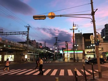 People walking on road at dusk