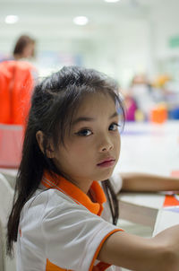 Close-up portrait of cute girl in school