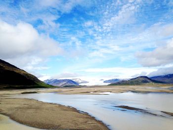 Scenic view of mountains against cloudy sky