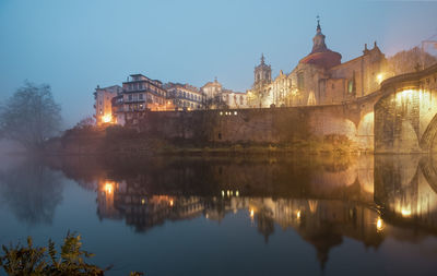 Reflection of illuminated buildings in lake