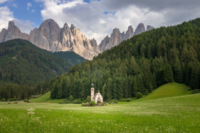 Scenic view of chapel in ranui, santa maddalena, in front of odles group mountains against sky 