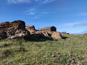 Rocks on field against sky