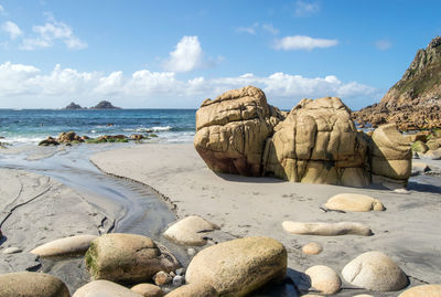 Rocks on beach against sky