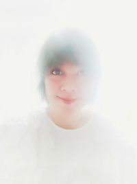 Portrait of young woman against white background