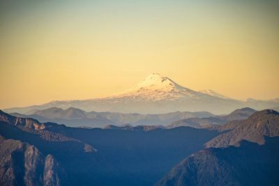 Scenic view of snowcapped mountains against sky during sunset