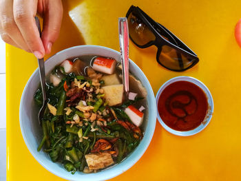 Close-up of hand holding food on table