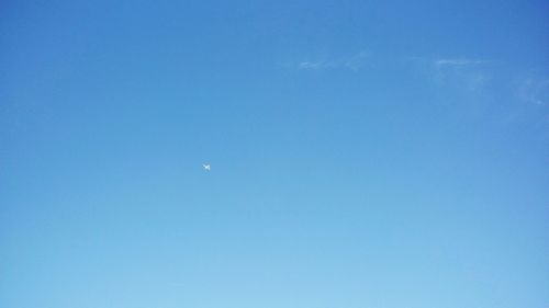 Low angle view of moon against blue sky