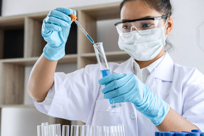 Portrait of woman holding test tube