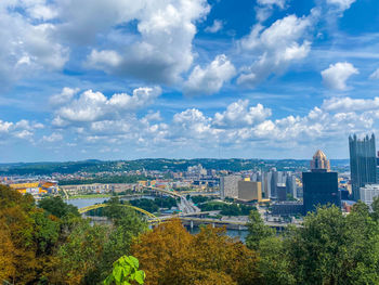 High angle view of trees and buildings against sky