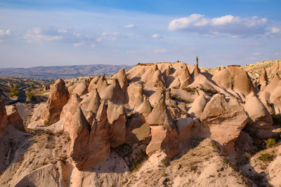 Rock formations on landscape against sky