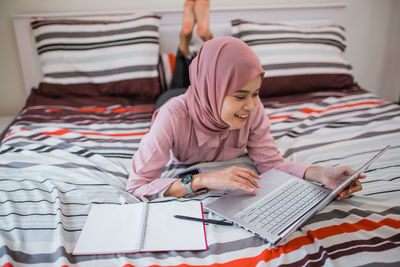 Portrait of woman reading book at home