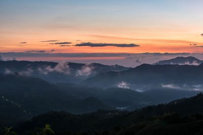 Scenic view of mountains against sky at sunset