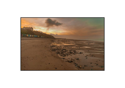 Scenic view of beach against sky during sunset