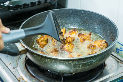 Close-up of person preparing food in container