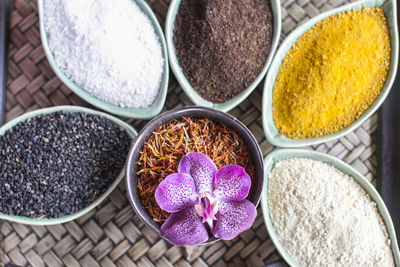 High angle view of orchid with spices in containers